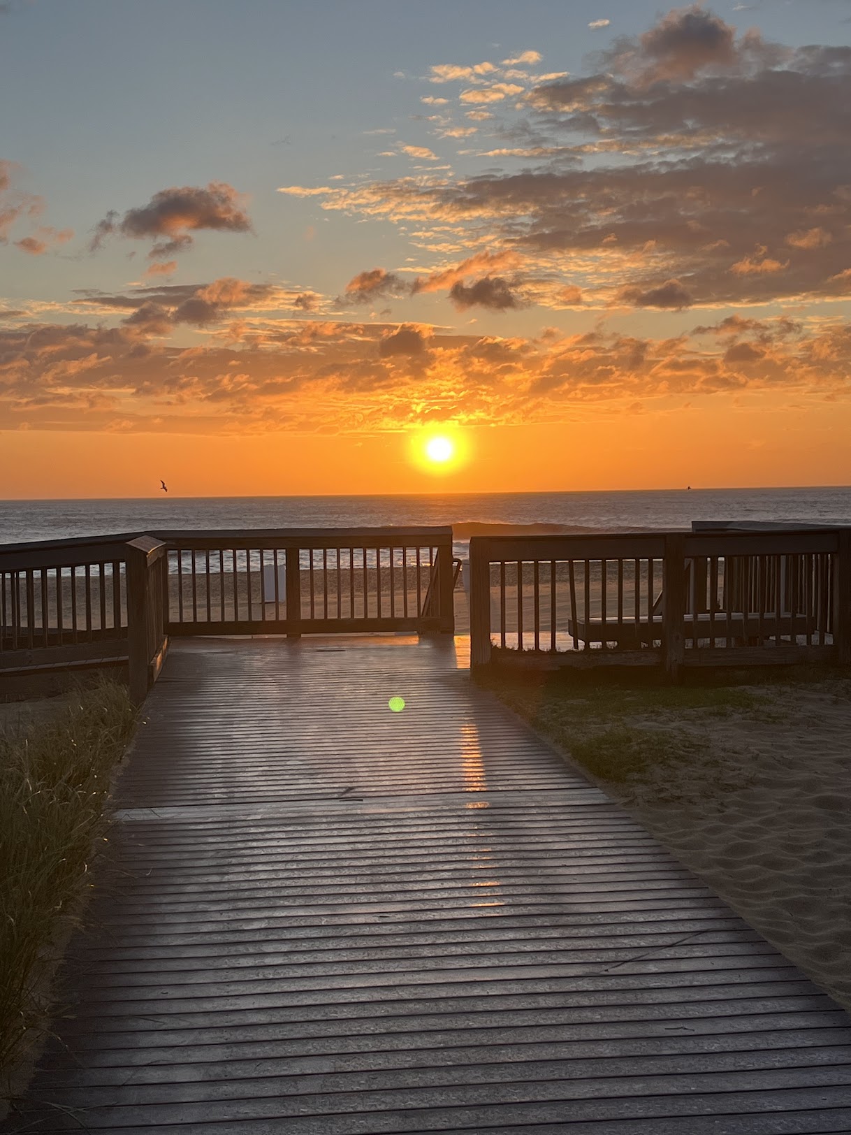 Golden sunset viewed from a Sandbridge boardwalk